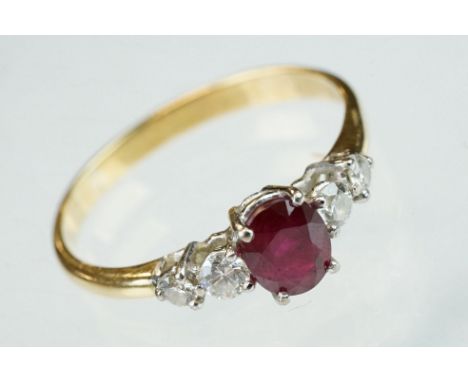 Ruby and diamond yellow and white gold ring, hallmarks rubbed, oval mixed cut ruby, dimensions approx 6.5mm x 5mm, four claw 