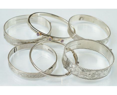 Four silver hinged bangles, together with a Rennie Macintosh style cubic zirconia set silver bangle and an amethyst set silve