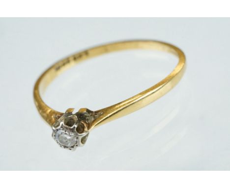 Diamond solitaire 18ct yellow gold platinum set ring, the round old cut diamond weighing approx 0.07 carat, illusion set, tap