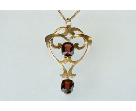 Art Nouveau garnet 9ct gold pendant, two oval cushion cut garnets, rubover set, measuring approx 8mm x 6.5mm, sinuous openwor