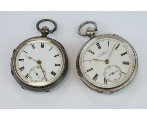 Two early 20th century silver open faced key wind pocket watches with engine turned cases and blank cartouches, to include a 