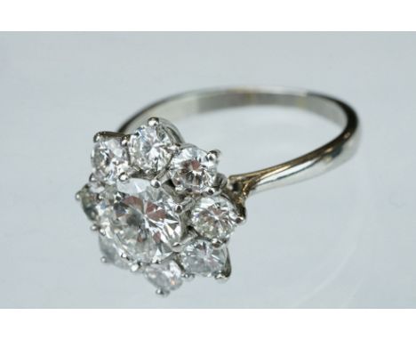 Diamond platinum flower head cluster ring, the principal round brilliant cut diamond weighing approx 1.40 carat, assessed cla