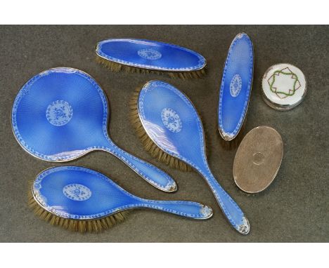 Five piece enamelled silver dressing table brush set (enamel damaged), a silver backed oval clothes brush, engine turned deco