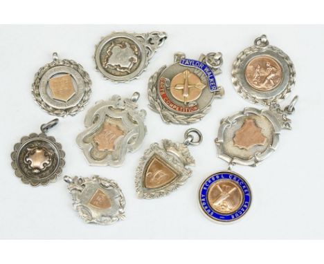 Ten Silver hallmarked sporting related watch fobs, early to mid 20th century, featuring darts and cricket examples with ename
