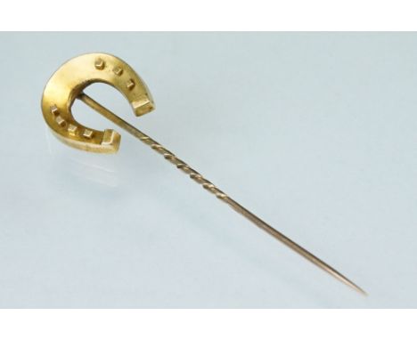 19th century yellow metal stick pin modelled as a horseshoe; length of head approx 2cm 