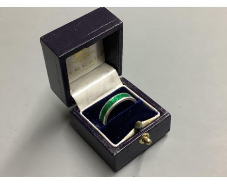   A Garrard's modern silver and green enamel band,size O.