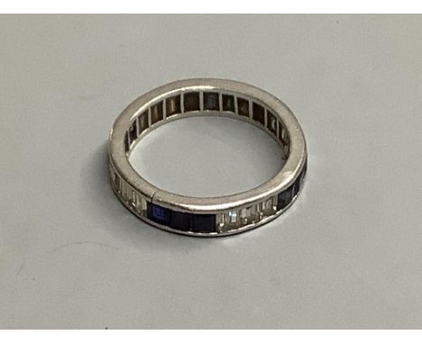   An 18ct white gold calibre-cut diamond and sapphire eternity ring(the diamonds and sapphires set three by three), size O, g