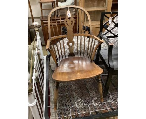   An early 20th century elm and beech Windsor comb back elbow chair, width 52cm, depth 50cm, height 98cm