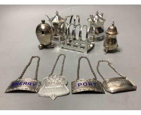   A pair of octagonal silver mustard pots and spoons, an egg-shaped salt, a baluster pepper, a small toast rack and four silv