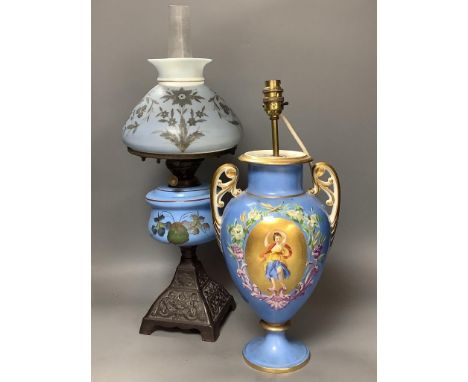   A French porcelain blue ground vase (converted to electricity) and a glass oil lamp,with cast metal base, blue glass reserv