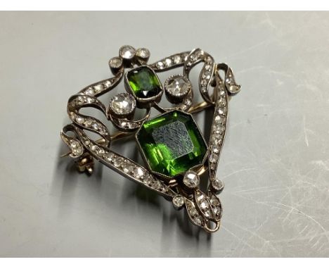   A Victorian gold and silver openwork pendant-cum-brooch set with rose-cut diamonds and emerald cut green paste,gross 7.8 gr