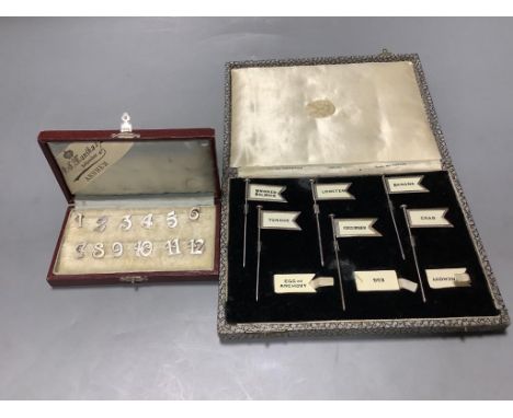   A cased set of twelve Dutch white metal number place settings, 12mm and  a cased set of six silver sandwich flags sticks, h
