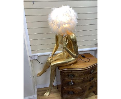   A large gilded seated female mannequin with illuminating feather shade, height 130cm