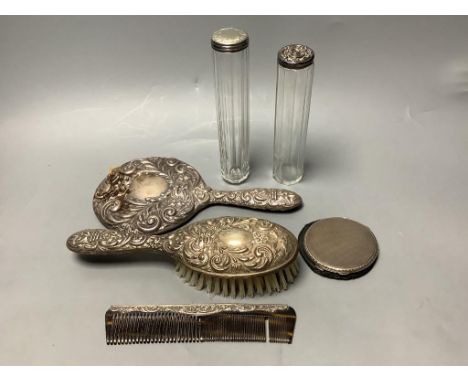   Two silver-topped narrow cylindrical toilet bottles, a silver backed-hand mirror and matching hairbrush, a comb and a silve