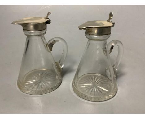   A pair of George V silver mounted glass whisky tot jugs, S. Blanckensee &amp; Sons Ltd, Birmingham, 1932/3, height 10.3cm.
