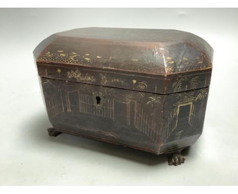   A late Georgian chinoiserie-lacquered tea caddyof shaped rectangular form on paw feet (loss to gilt decoration and lacking 