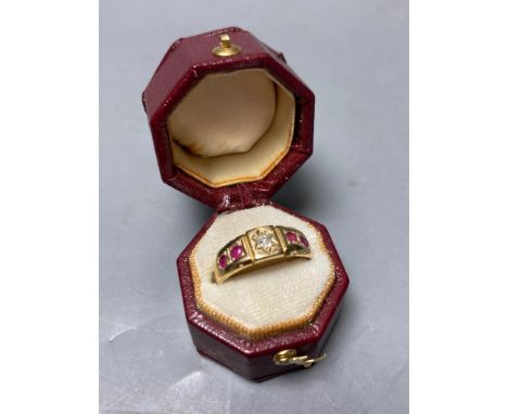   An early 20th century yellow metal, four stone ruby and single stone diamond set half hoop ring,size N/O, gross 2.9 grams.