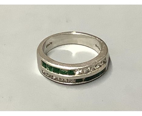   A platinum, emerald and diamond ring,channel set with two rows of emeralds and diamonds (some stones damaged), size N/O, gr