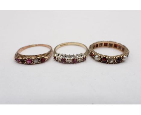 A Garnet, Paste and Seed Pearl Eternity Ring ring size J 1/2 A/F, a Ruby and Diamond seven stone Ring in 9ct gold, ring size 