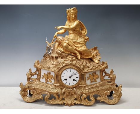 A 19th Century French gilt metal Figural Mantle Clock with neo-classical maiden surmount, white metal dial and acanthus leaf 