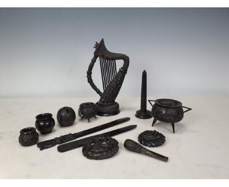 A Collection of bog oak Souvenirs of Ireland, mostly carved, including an ornate Harp, turned and carved, 8in H, two Paper Kn