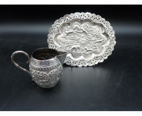 An Indian silver Jug and small oval Tray embossed and chased hunting scenes, landscape frieze, etc 
