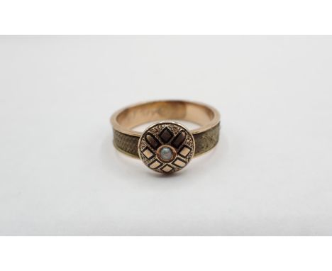 A 19th Century Mourning Ring set single seed pearl within black enamel design, woven hair to band, engraved 'F Taylor' to ins