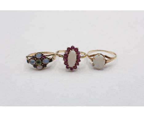 An early Victorian gem-set Ring set opal, moonstones, foil backed red and green stones ring size ), an Opal and ruby Cluster 