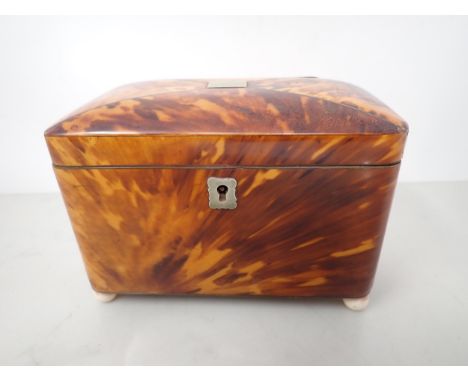 A 19th Century tortoiseshell Tea Caddy with two interior lidded divisions, on bun feet, 6¼in 