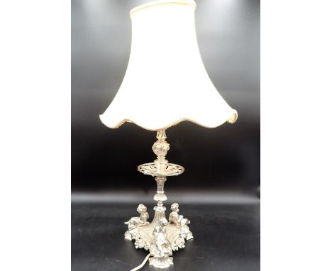 A plated Table Lamp with mask decorated column on triangular base with three cherubs holding floral swags, 15in, fitted elect