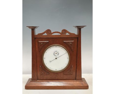 An Arts and Crafts style oak Mantel Clock the circular dial and pierced surmount, 14in H 