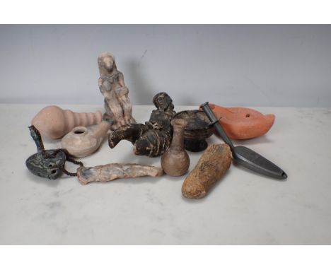 A small collection of Egyptian and other artefacts with oil lamps, carved figures, vase, etc 