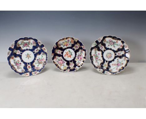 Two Worcester scale blue Plates with shaped rims, floral painted ponds, richly gilt borders, and a Coalport similar Plate 