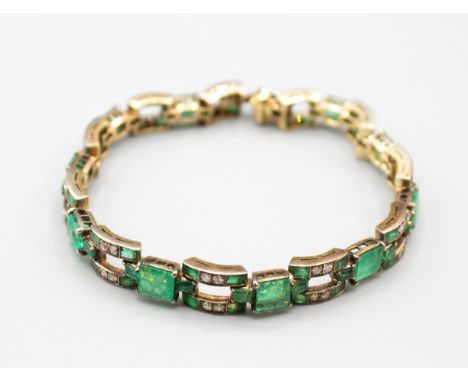 An Art Deco Emerald and Diamond articulated line Bracelet comprised of eleven rectangular links each rubover and pavé-set fou