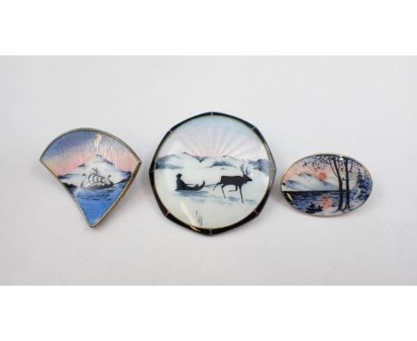 Three Norwegian silver and enamel Silhouette Brooches depicting; Viking longboat 35mm wide, reindeer pulling sled 38mm diamet
