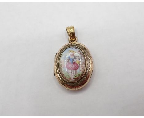 A yellow metal oval Locket the front with enamel plaque painted girl carrying a basket, approx 25mm top to bottom excluding b