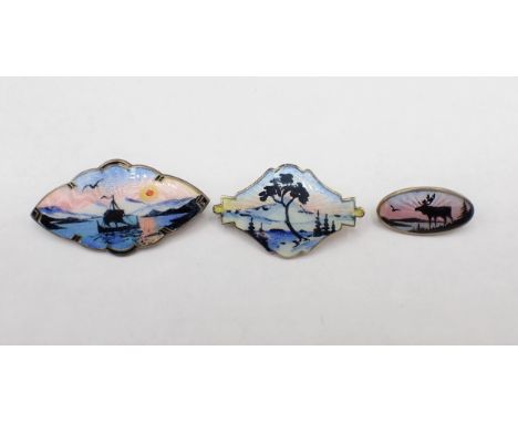 Three Norwegian silver and enamel Silhouette Brooches depicting; sailing boat at sunset 45mm wide, snowy landscape 38mm wide 