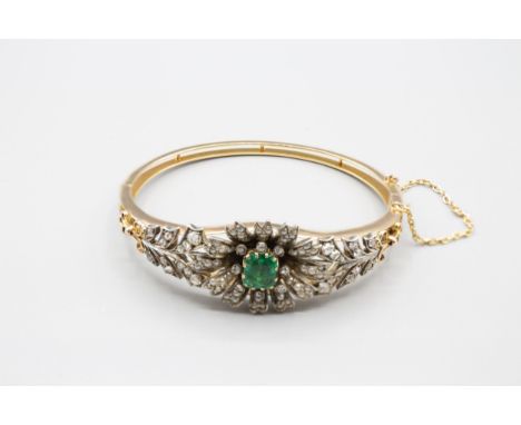 An Emerald, Seed Pearl and Diamond hinged Bangle the front with flower effect claw-set step-cut emerald within rose-cut diamo