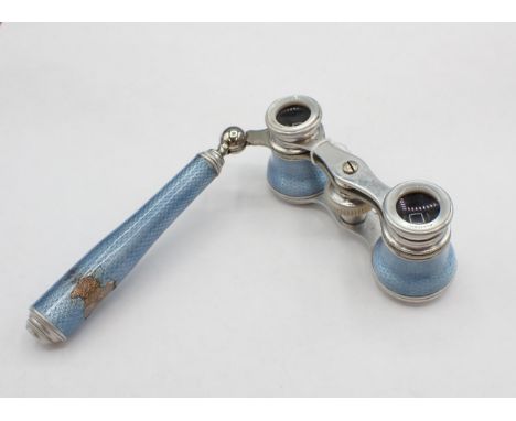 A pair of pale blue guilloche enamel Opera Glasses by Asprey, engraved 'Sybil from Giacomo Puccini'. Some loss of enamel to h