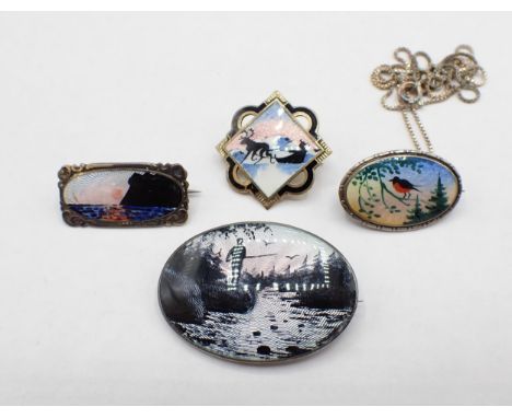 Four Norwegian silver and enamel Silhouette Brooches depicting; fisherman 40mm wide, coastal sunset 28mm wide, reindeer with 