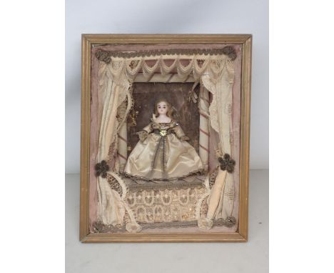 A 19th Century Doll's Diorama with porcelain headed Doll in silk dress standing on stage with theatre curtains within a paint