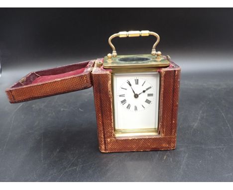 A brass cased Carriage Clock with white enamel dial, cylinder escapement, 5in, in original travelling case 