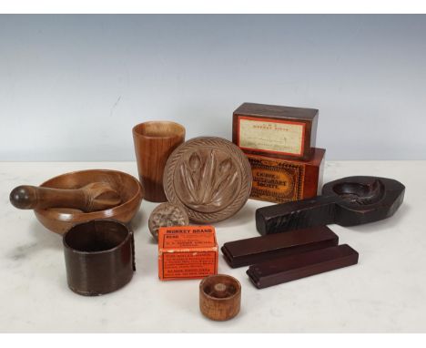 A treen Butter Mould with handle, having design of tulips, 4¾in, another smaller, two Church Missionary Money Boxes, a lime-w
