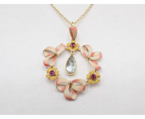 A circular ribbon and flower effect Enamel, Ruby and Aquamarine Pendant claw-set round rubies to flowers and suspending drop 