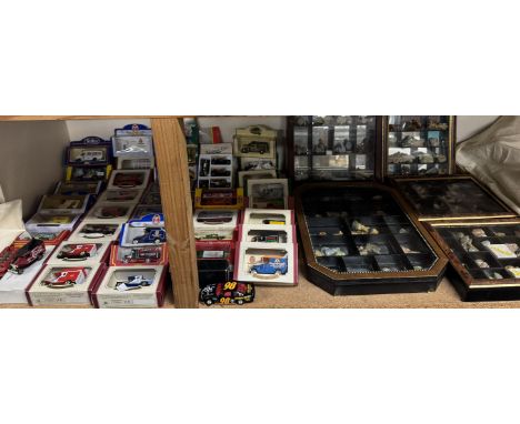 A large collection of Wade Whimsies contained in sectional mirrored wall cabinets and a collection of die cast model cars and