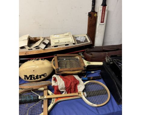 A mixed lot including a model speedboat, tennis rackets, cricket bats, leather bag, bowls, Smiths Premier typewriter, horse b