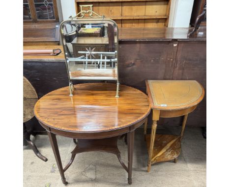 An Edwardian mahogany occasional table of oval form with four tapering legs and casters united by an undertier together with 