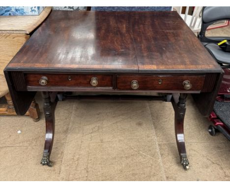 A 19th century crossbanded mahogany sofa table on turned legs and splayed feet