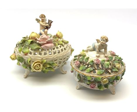 A Schierholz porcelain pot pourri basket and cover, c.1900, the pierced body raised upon three scroll feet, encrusted with vi