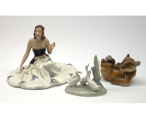 A Royal Dux figurine, modelled as a seated female figure with outspread gown, with pink triangle mark beneath, together with 